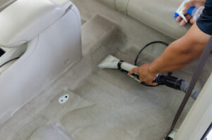 The Carpet Cleaners - close-up view of cleaning white carpet with professional vacuum